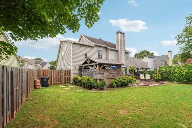 a view of a house with a yard and sitting area