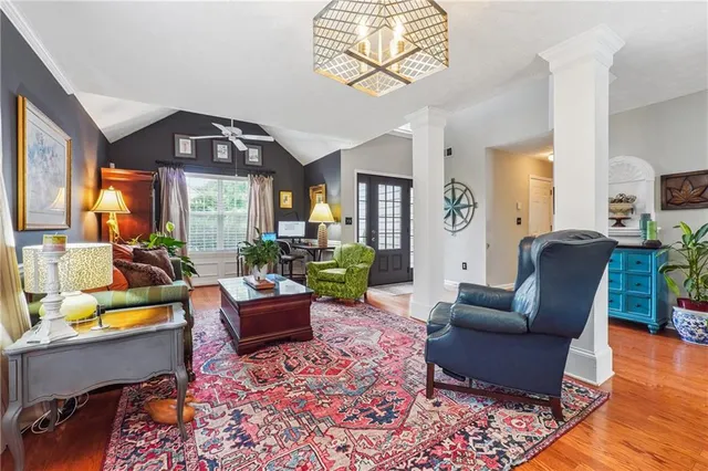 a living room with furniture fireplace and a large window