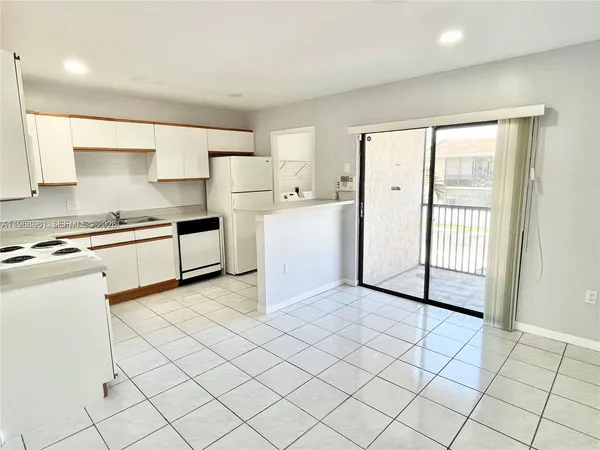 a kitchen with a stove a sink and a refrigerator