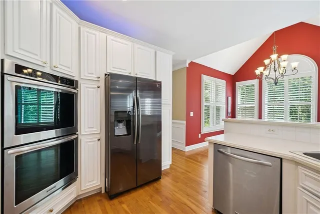 a spacious bedroom with a bed and wooden floor