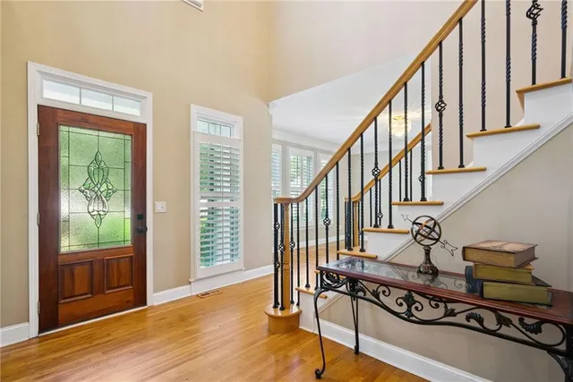 a view of an entryway with wooden floor and windows