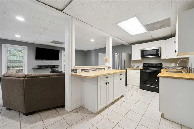 an aerial view of a house with a swimming pool yard and outdoor seating