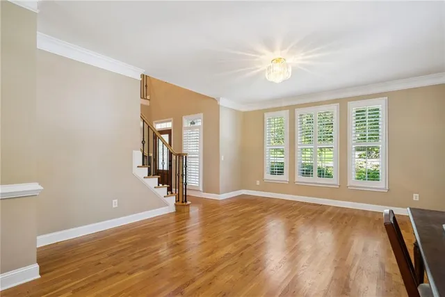 a dining room with furniture window outside view and wooden floor