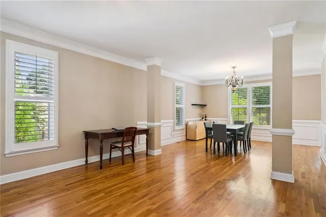 a dining room with furniture and wooden floor