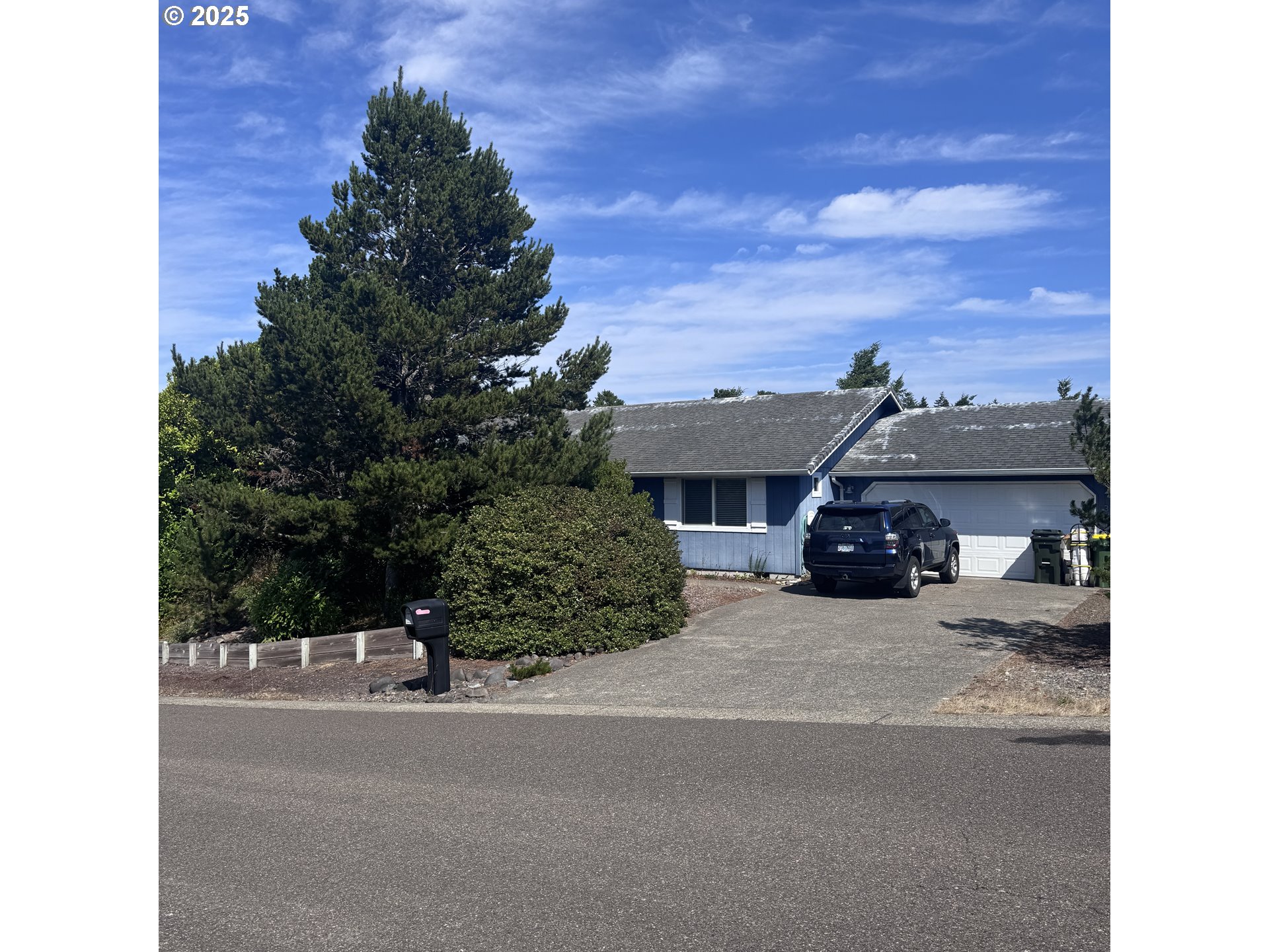 a view of house with outdoor space and parking