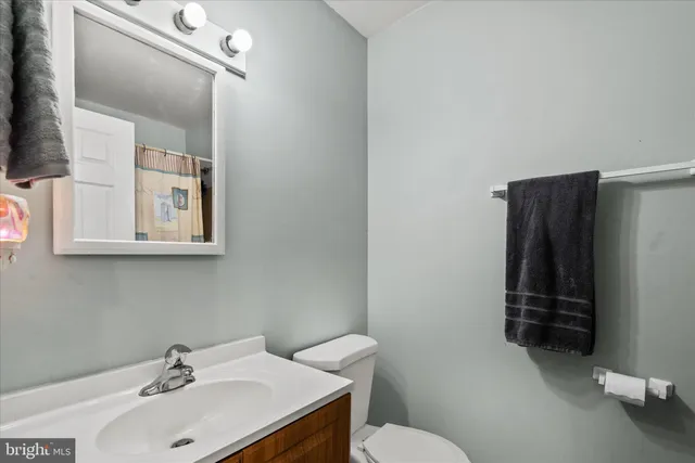a bathroom with a sink toilet and mirror