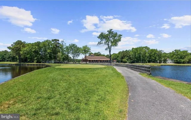 a view of a yard with wooden fence