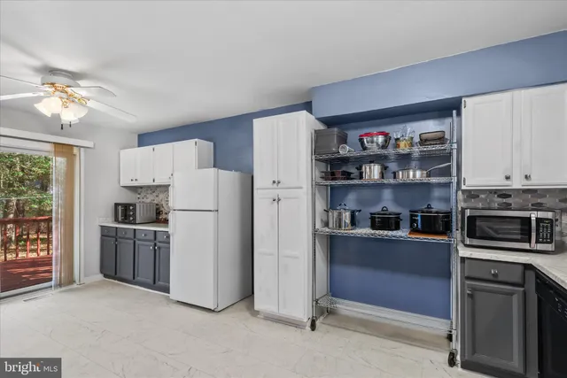 a kitchen with stainless steel appliances granite countertop a refrigerator and a stove top oven