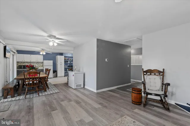 a dining room with furniture and wooden floor