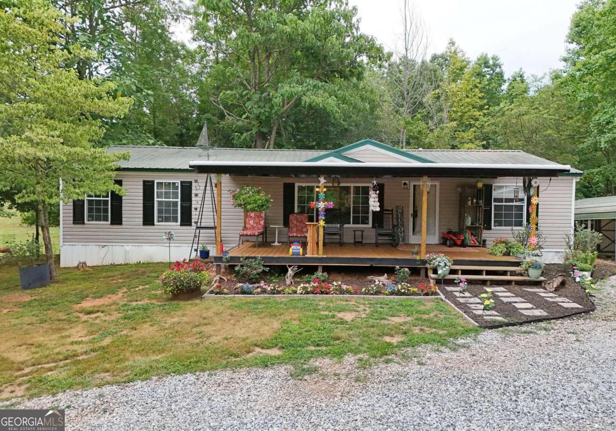 a view of a house with a yard balcony and chairs