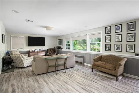 a living room with furniture flat screen tv and a couch