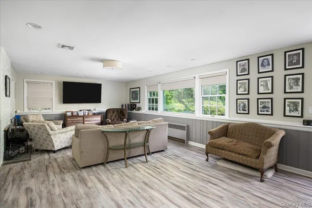a living room with furniture flat screen tv and a couch