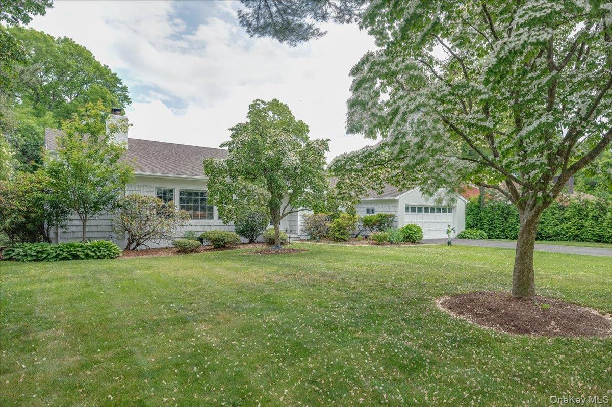 4 Wagon Wheel Road Mamaroneck, NY 10543 - Photo 2 of 31 View of front of home featuring a front yard, a chimney, and roof with shingles