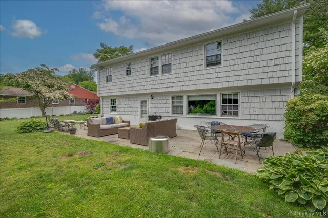 a backyard of a house with table and chairs