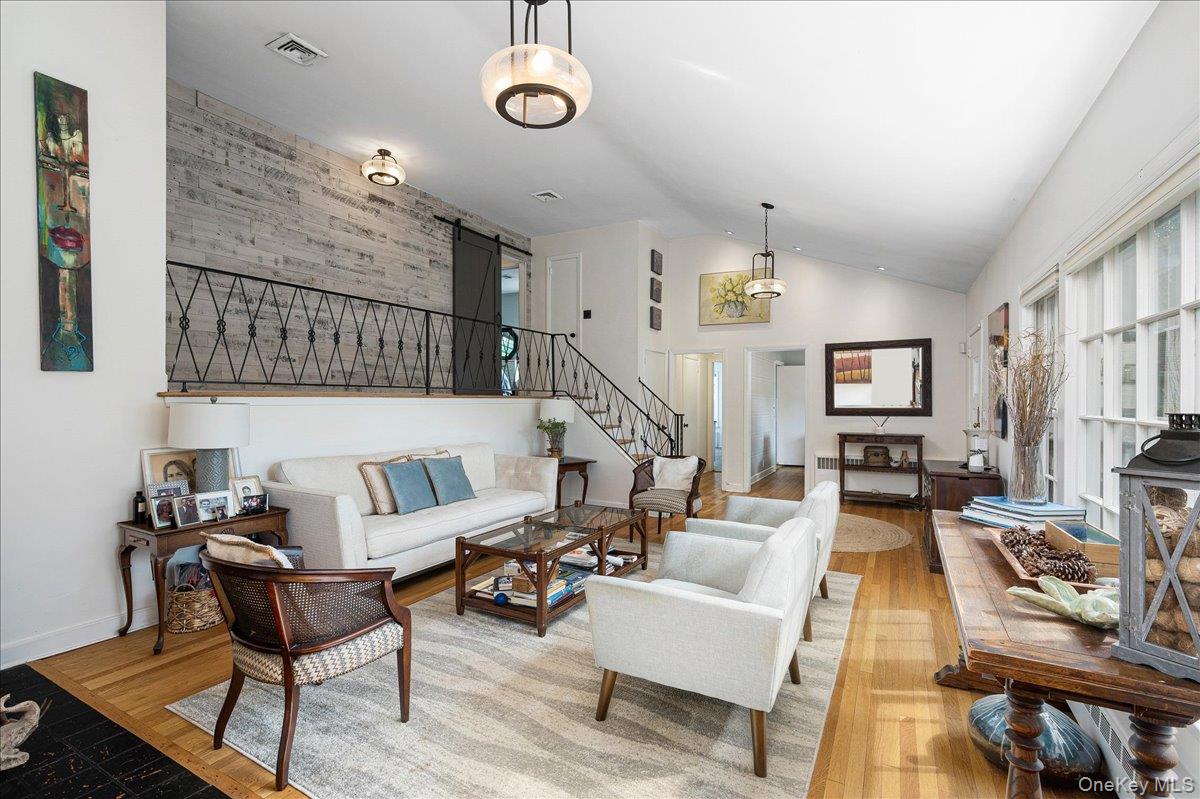 4 Wagon Wheel Road Mamaroneck, NY 10543 - Photo 7 of 31 Living area featuring stairway, wood finished floors, and high vaulted ceiling