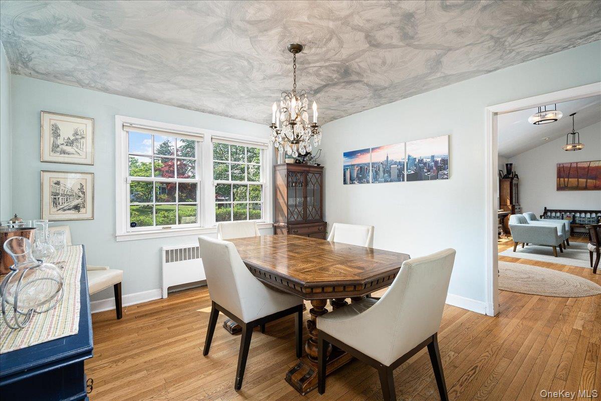 4 Wagon Wheel Road Mamaroneck, NY 10543 - Photo 9 of 31 Dining space with a chandelier, radiator, and light wood finished floors