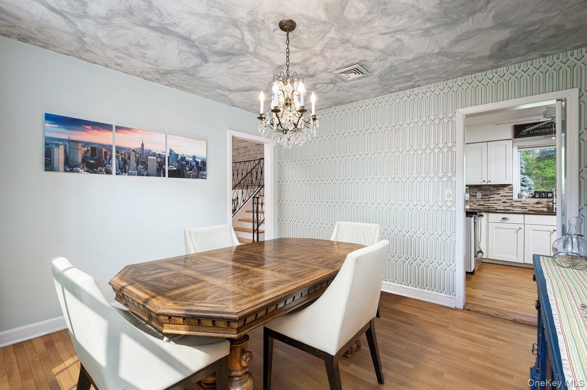 4 Wagon Wheel Road Mamaroneck, NY 10543 - Photo 10 of 31 Dining space with a chandelier, light wood-type flooring, and wallpapered walls