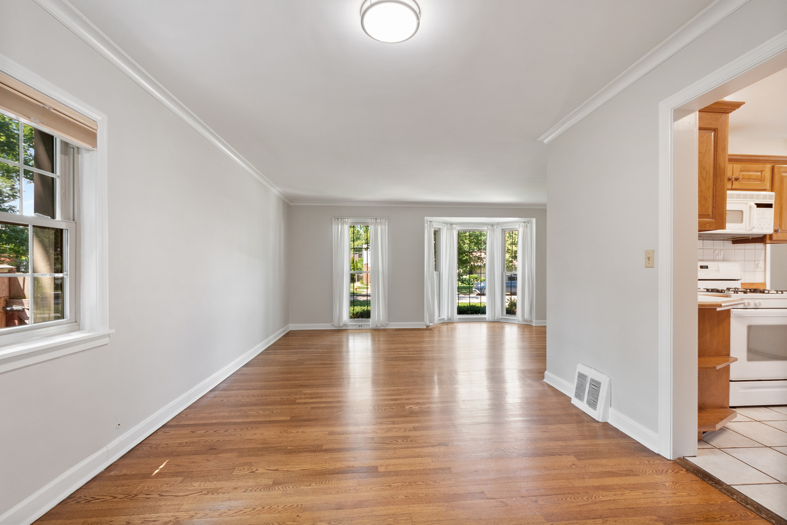 103 North Home Avenue Park Ridge, IL 60068 - Photo 8 of 28 a view of an empty room with wooden floor and a window