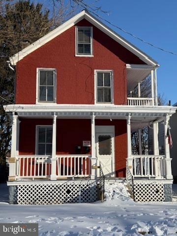 a view of a house with wooden door and deck