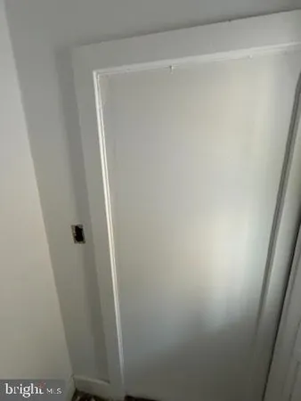 a view of a livingroom with wooden floor and staircase