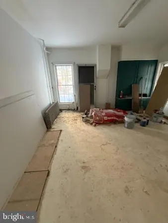 a room with water heater and a cabinet