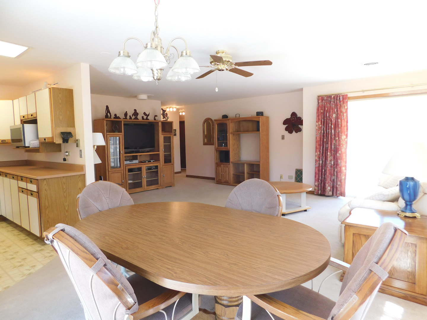 4496 West Sandwich Road Sandwich, IL 60548 - Photo 13 of 37 a dining room with wooden floor and chandelier
