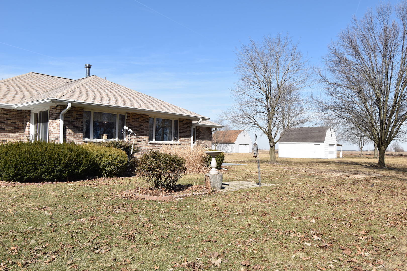 4496 West Sandwich Road Sandwich, IL 60548 - Photo 26 of 37 a front view of a house with a yard covered in snow