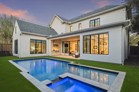 a view of a house with pool and wooden floor