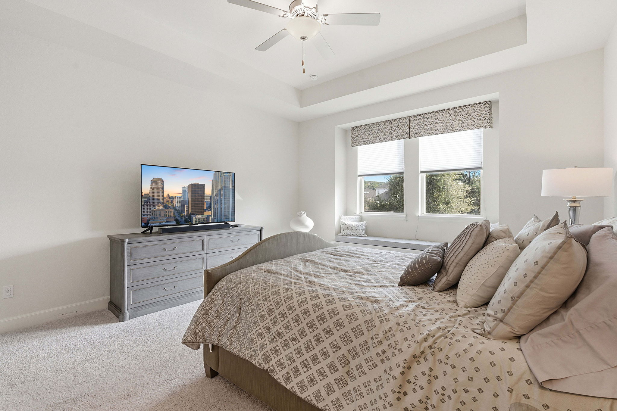 18917 Grape Seed Cove Austin, TX 78738 - Photo 22 of 33 Carpeted bedroom with a raised ceiling and a ceiling fan