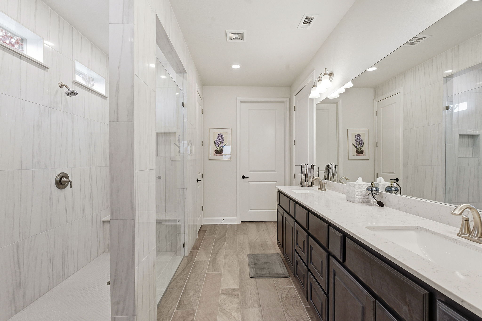18917 Grape Seed Cove Austin, TX 78738 - Photo 25 of 33 Bathroom featuring a walk in shower, double vanity, wood tiled floors, and recessed lighting