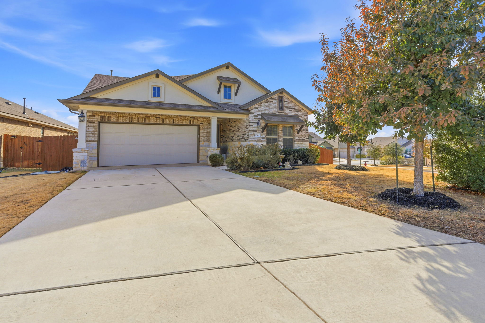 18917 Grape Seed Cove Austin, TX 78738 - Photo 33 of 33 View of front of property with concrete driveway, stucco siding, and a garage