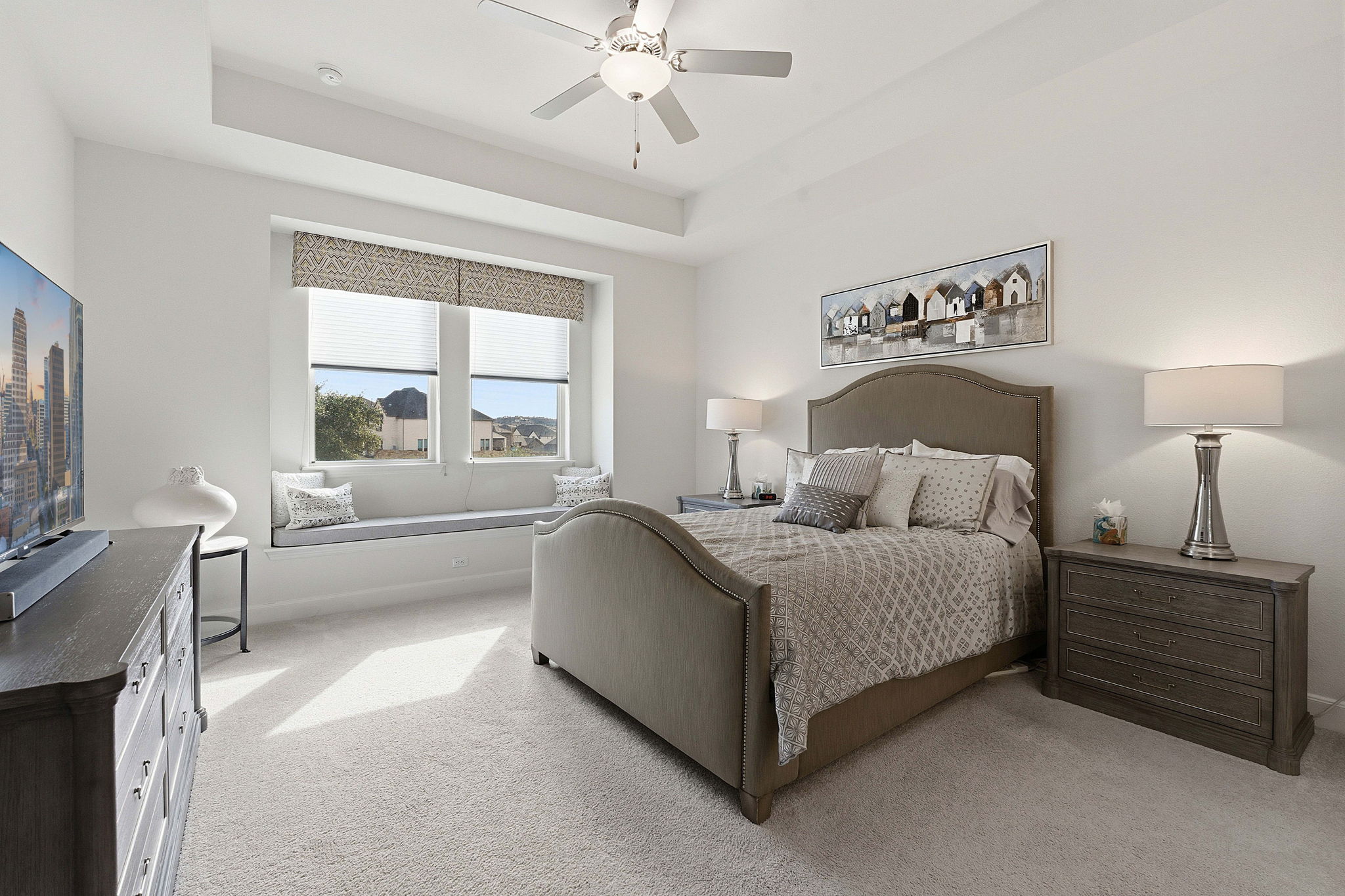 18917 Grape Seed Cove Austin, TX 78738 - Photo 4 of 33 Bedroom with carpet flooring, ceiling fan, and a tray ceiling