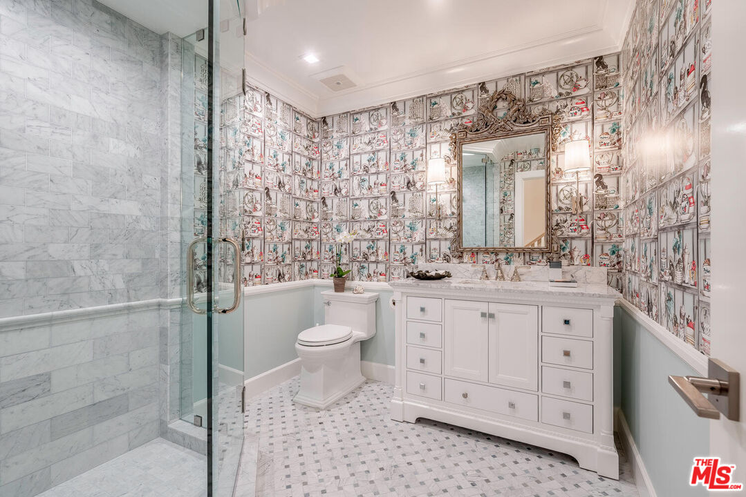 10821 Savona Road Los Angeles, CA 90077 - Photo 11 of 26 a bathroom with a granite countertop sink toilet and shower