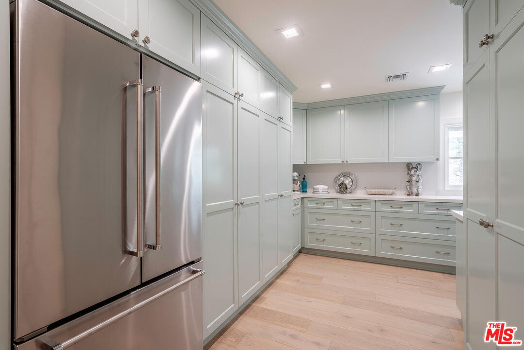 10821 Savona Road Los Angeles, CA 90077 - Photo 12 of 26 a bathroom with a double vanity sink mirror and shower