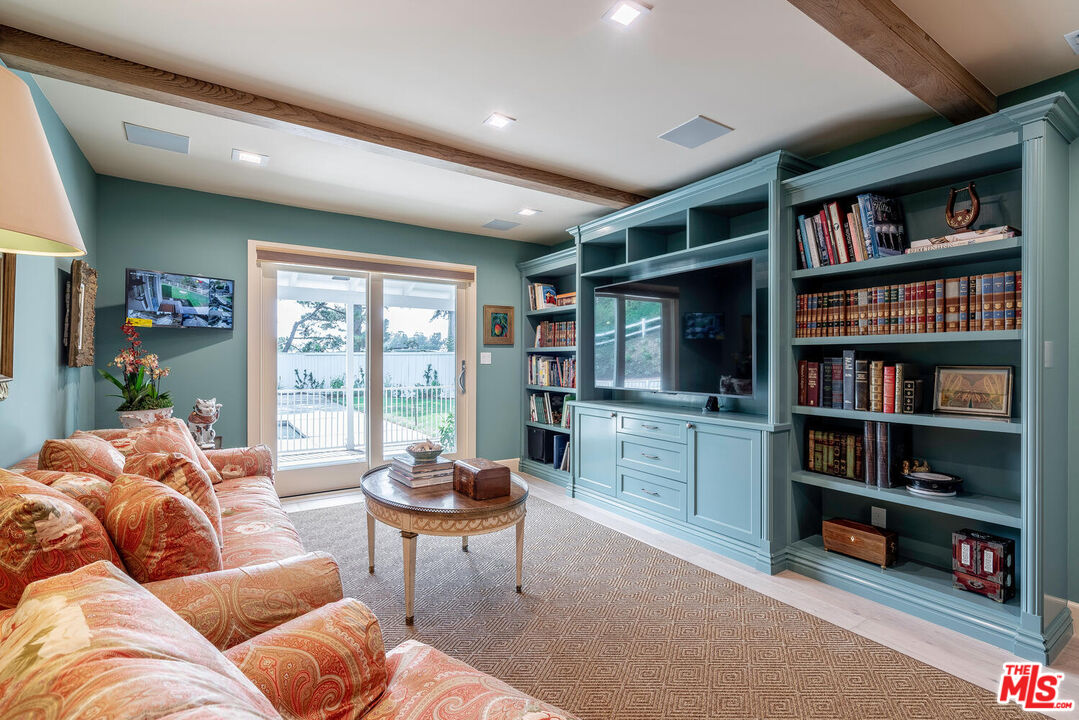 10821 Savona Road Los Angeles, CA 90077 - Photo 14 of 26 a living room with furniture and a book shelf