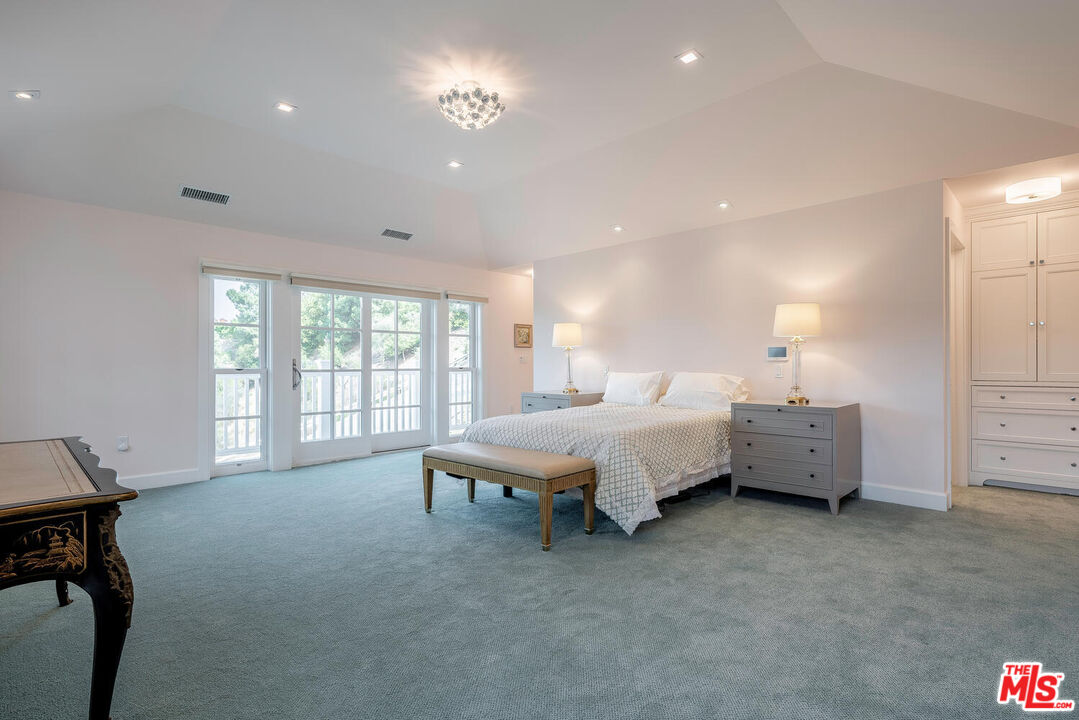 10821 Savona Road Los Angeles, CA 90077 - Photo 15 of 26 a spacious bedroom with a bed and furniture