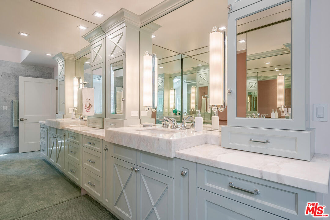 10821 Savona Road Los Angeles, CA 90077 - Photo 17 of 26 a bathroom with double sink and a large mirror