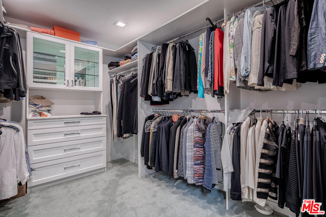 10821 Savona Road Los Angeles, CA 90077 - Photo 18 of 26 a view of walk in closet with clothes