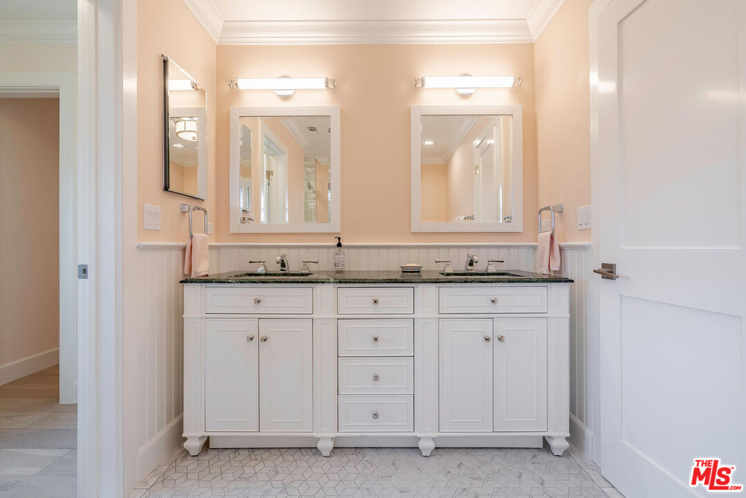 10821 Savona Road Los Angeles, CA 90077 - Photo 20 of 26 a bathroom with a granite countertop sink and a mirror