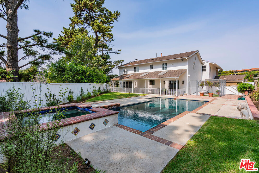 10821 Savona Road Los Angeles, CA 90077 - Photo 2 of 26 a view of a house with backyard and sitting area