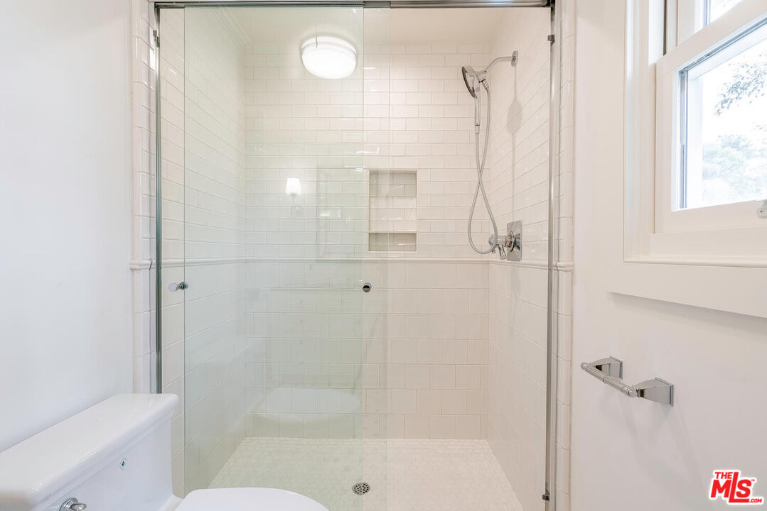 10821 Savona Road Los Angeles, CA 90077 - Photo 22 of 26 a bathroom with a bathtub and a shower
