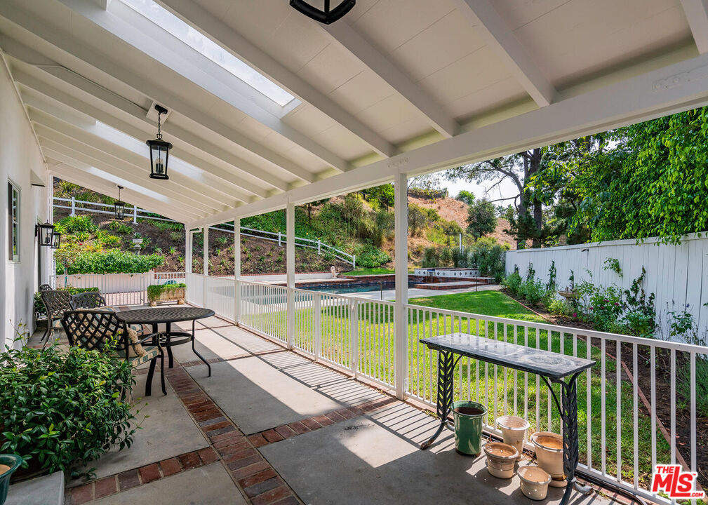 10821 Savona Road Los Angeles, CA 90077 - Photo 23 of 26 a view of a chair and tables in the balcony