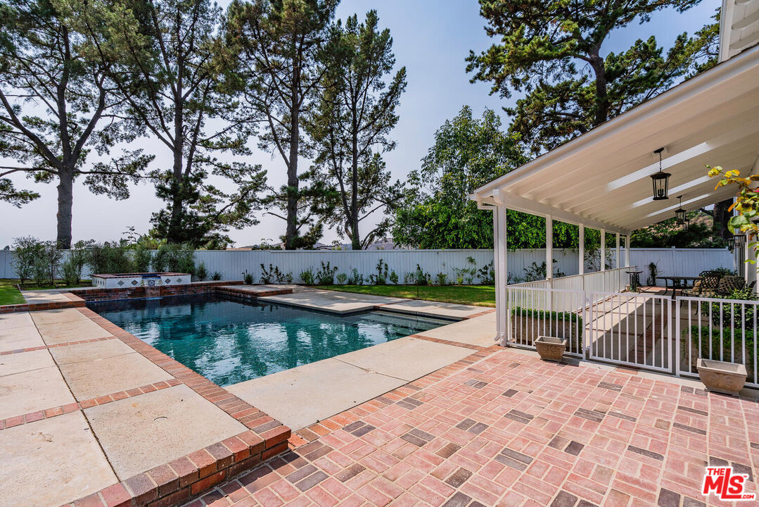 10821 Savona Road Los Angeles, CA 90077 - Photo 24 of 26 a view of a swimming pool with a patio and a garden