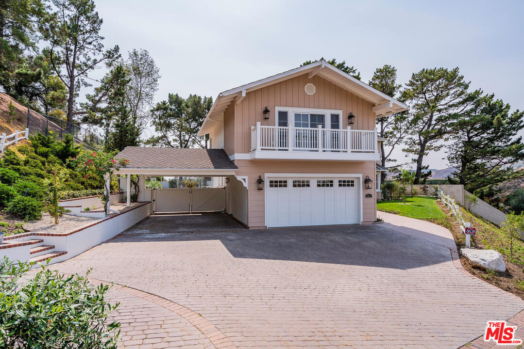 10821 Savona Road Los Angeles, CA 90077 - Photo 3 of 26 a front view of a house with a yard