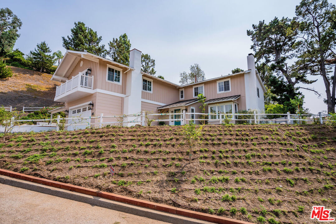 10821 Savona Road Los Angeles, CA 90077 - Photo 4 of 26 a front view of a house with a yard