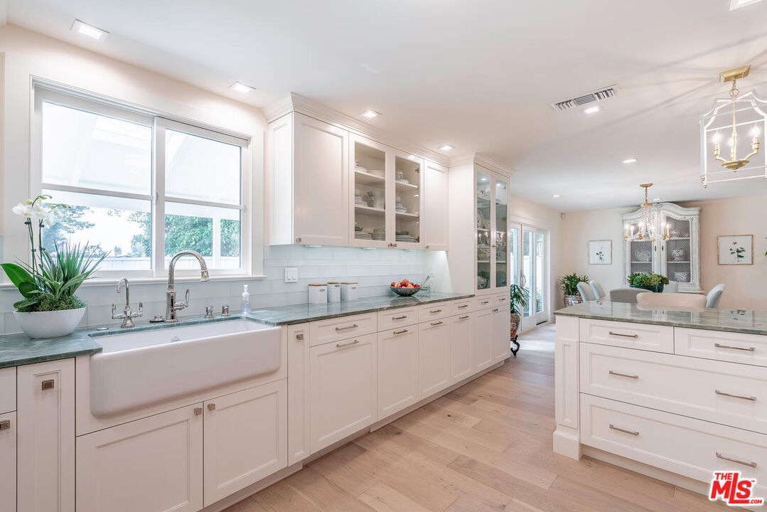 10821 Savona Road Los Angeles, CA 90077 - Photo 10 of 26 a large white kitchen with a large window