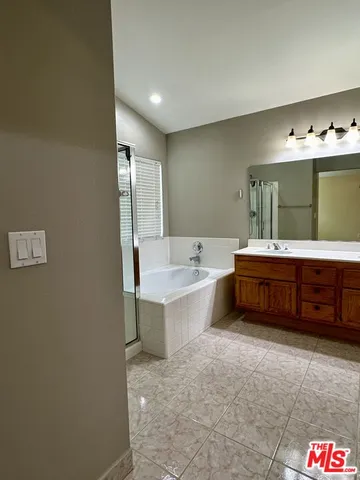 a bathroom with a bathtub sink and mirror