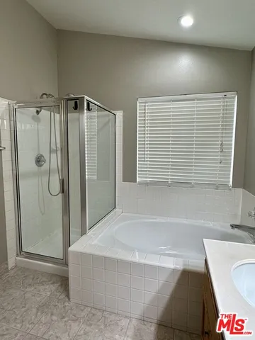 a bathroom with a bathtub and a shower