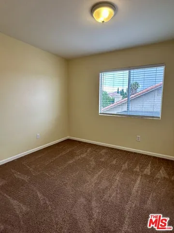 an empty room with a painting on the wall