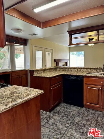 a kitchen with granite countertop sink cabinets and granite counter tops